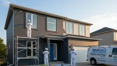 Professional house painters working on exterior home in Highland Park, IL